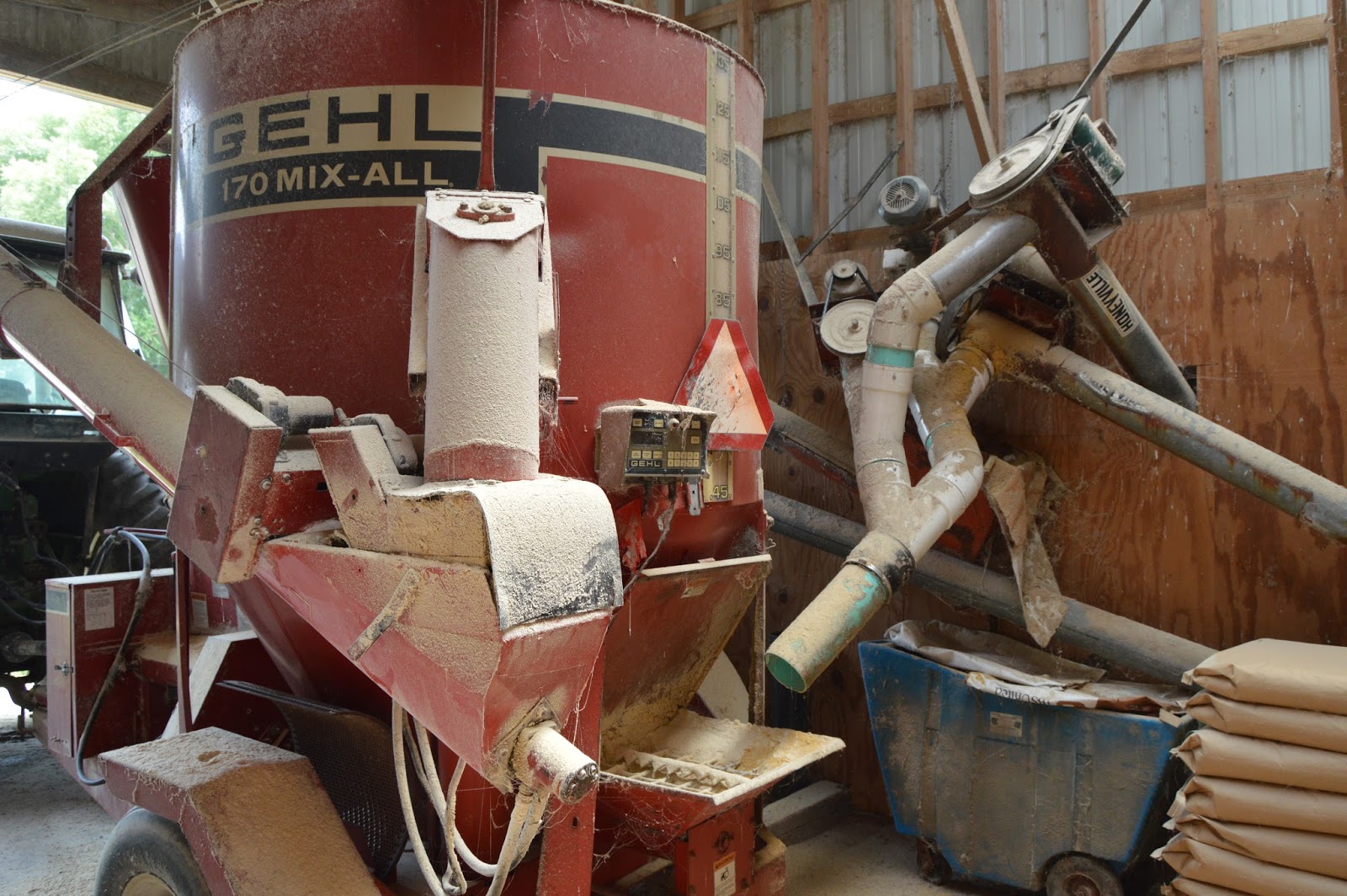 Industrial History Tractor implement to grind, mix, and deliver feed