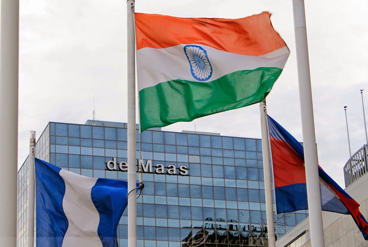 Indian Flag flying high, behind is the De Mass Building