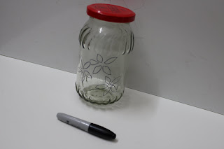 drawing a design on jar using marker