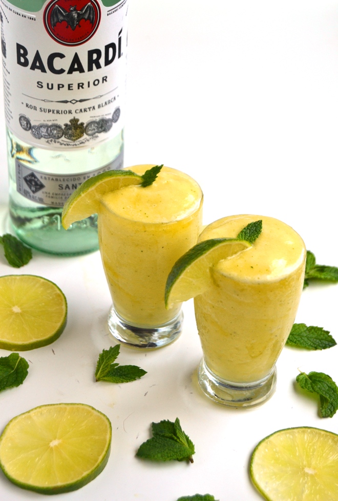 Frozen Pineapple Mojito is a lighter take on a typical mojito with just 5 ingredients: frozen pineapple, fresh lime juice, orange juice, mint leaves and rum for a refreshing beverage! www.nutritionistreviews.com