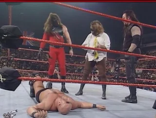 WWE / WWF Capital Carnage 1998 - Mankind, Kane and Undertaker stand over a fallen Stone Cold Steve Austin