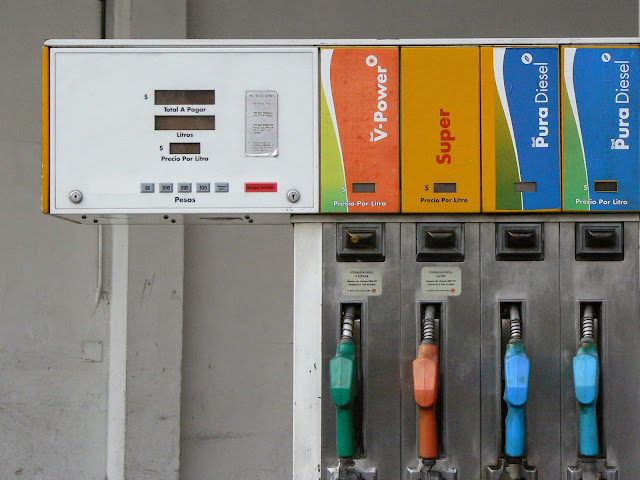 Close up photograph of a gas pump with prices in pesos and labels in Spanish