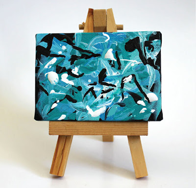 small abstract painting on an easel