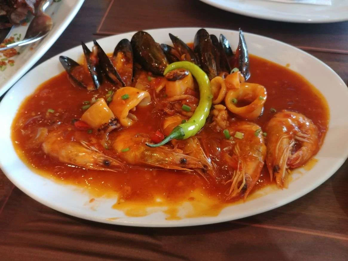 An appetizer of mixed shrimps, mussels, and squid in red chili sauce at Mesa Filipino Moderne