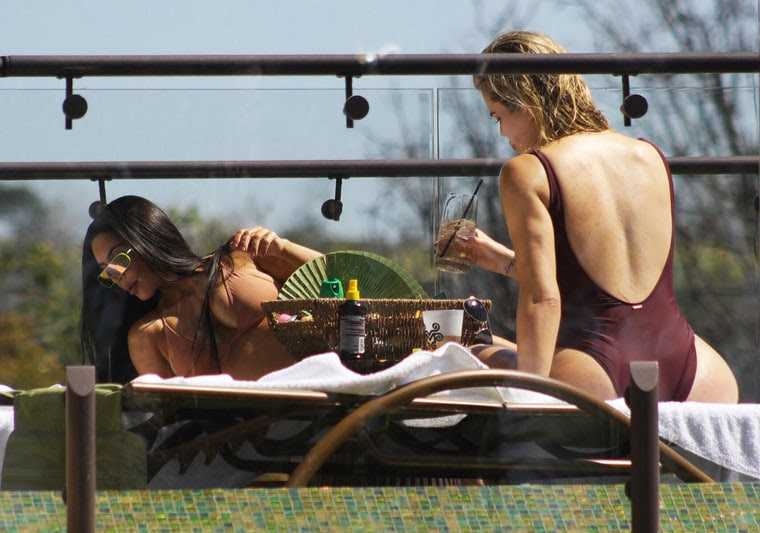 Kim and khloe kardashian relax in swimsuits in costa rica. 