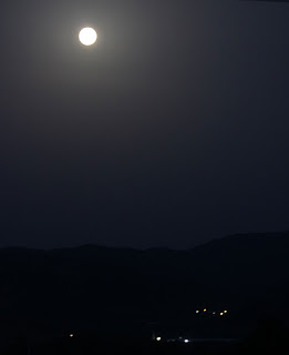 Bright moon above local town lights Bright moon above local town lights