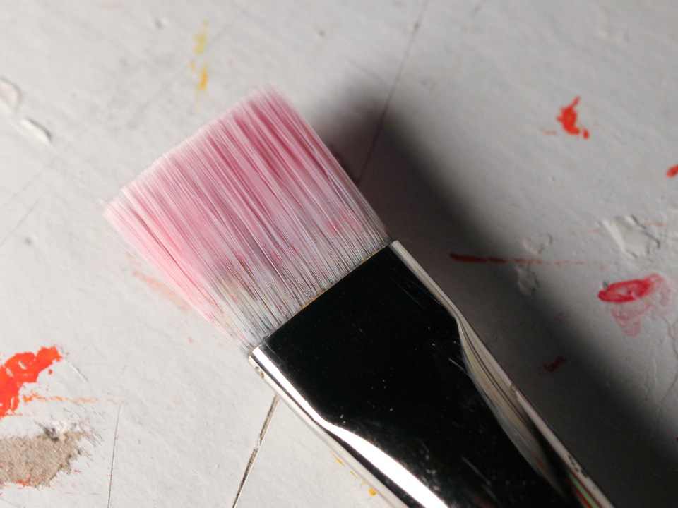 the paintbrush after it had dried acrylic paint removed from the bristles