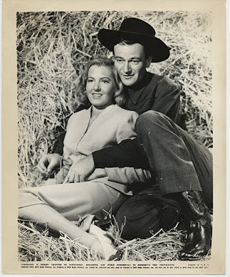 Jean Arthur and John Wayne in A Lady takes a Chance (1943)