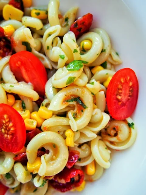 a close up of tomato and sweetcorn pasta salad