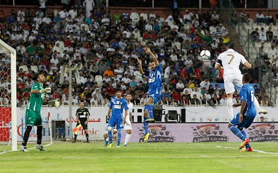 Cristiano Ronaldo jumping to score a goal against Kuwait