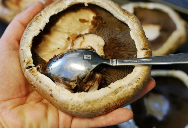 Scraping Out Gills of Portabella Mushroom Cap With a Spoon Image