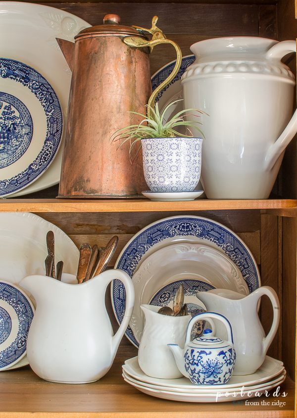 blue and white dishes with copper accents