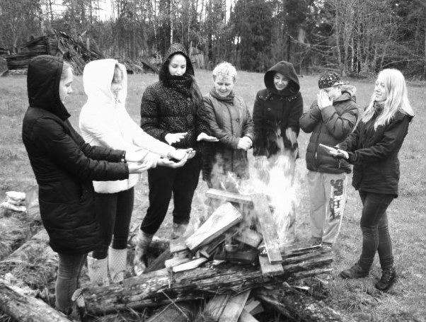 Valles vidusskolas audzēkņi un skolotāja Alda Zālmane Meža dienu pasākuma noslēgumā pie ugunskura