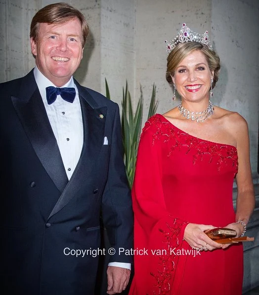 Queen Maxima at gala dinner wore a red gown by Valentino. Queen Maxima wear diamond tiara. diamond earrings. Mrs Laura Mattarella