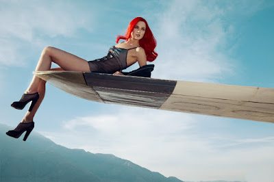 model hanging off of airplane wing, fashion and beauty photographer nyc, jamie nelson