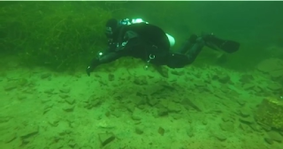 scuba diver in cold waters wearing a drysuit