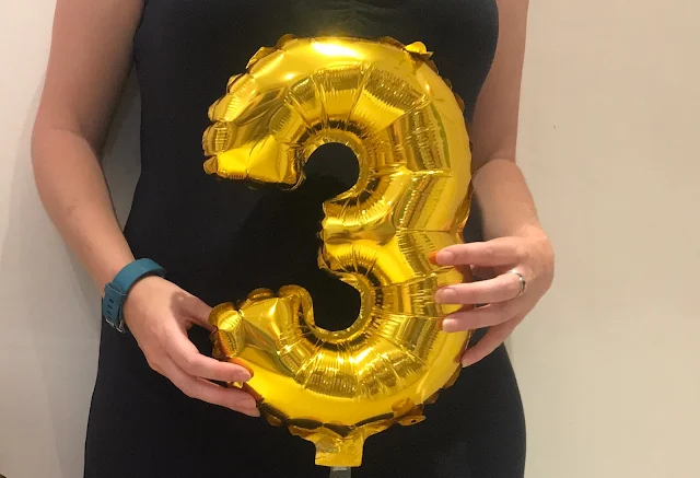 Holding a number 3 balloon next to my belly