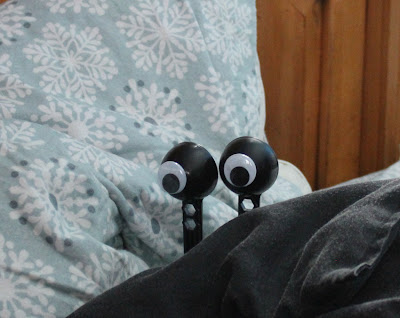 googly eyes hiding in bed