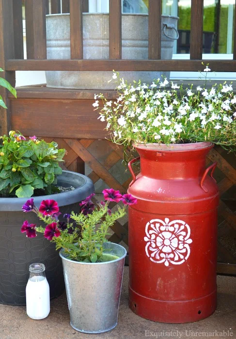 Milk can and upcycled pots with flowers