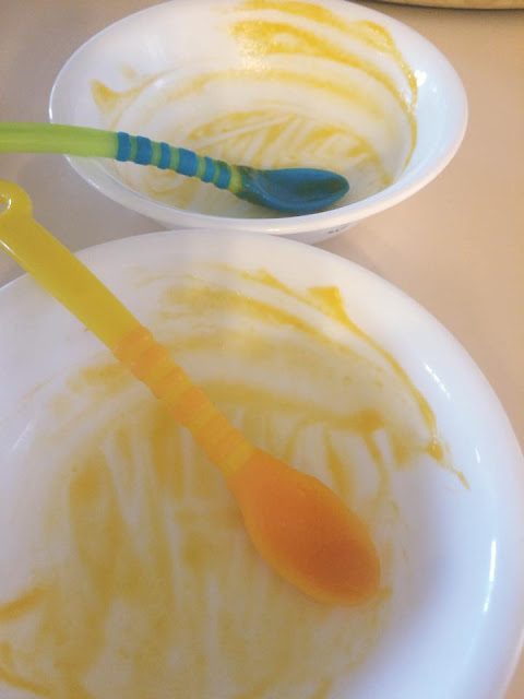 Two empty baby bowls with spoons.