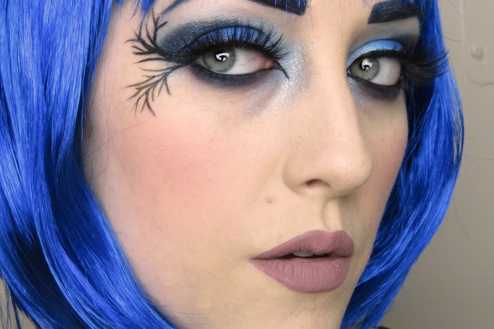 woman with shimmery makeup of a dark fairy