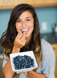 Smiling Brunette with Bowl of Blueberries