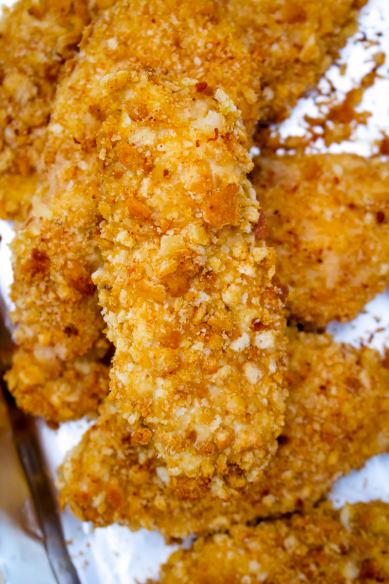 Crouton Crusted Chicken Tenders are coated in a golden, crunchy, crushed crouton coating that will make you forget all about traditional breadcrumbs! #chickentenders #bakedchicken