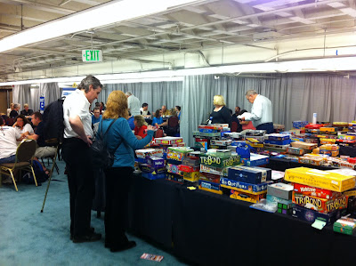 Three tables with hundreds of board games on them