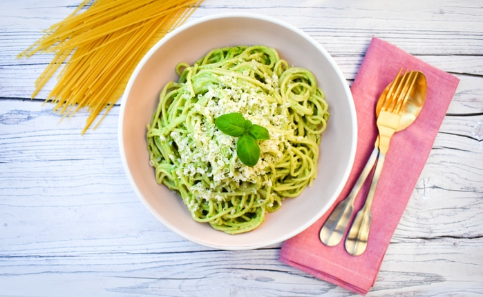 Kale and Cashew Pesto Spaghetti in a pink bowl
