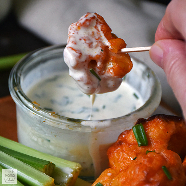 Baked Buffalo Cauliflower Bites | by Life Tastes Good with a dairy-free ranch dipping sauce are loaded with all the flavors of one of our favorite Monday Night Football appetizers, but in a better-for-you option. These spicy bites are meatless and dairy free too! #LTGrecipes
