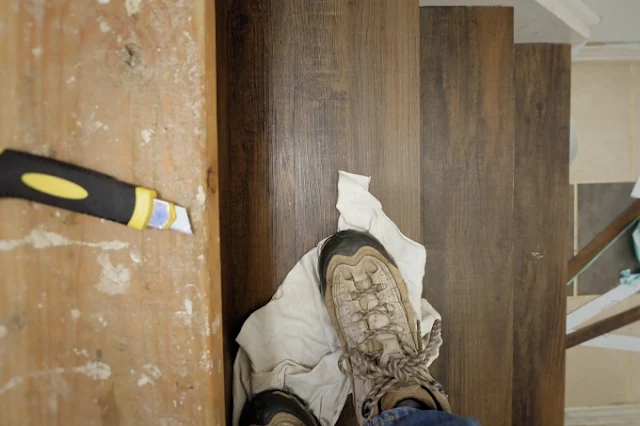 smoothing the tiles down with my foot and a rag