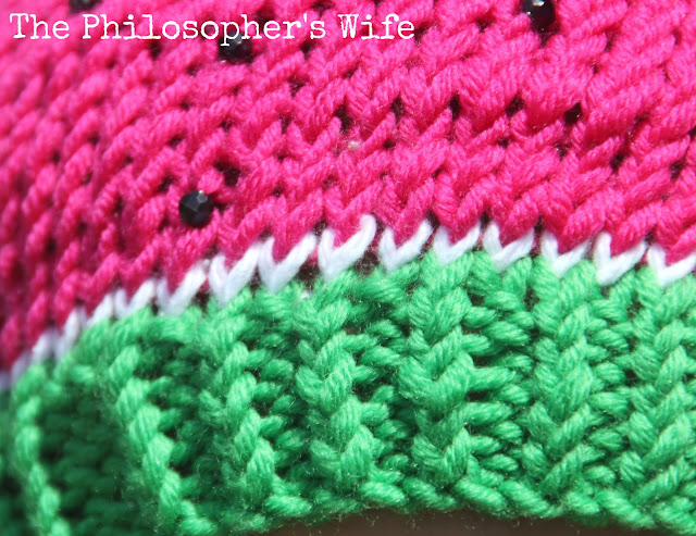This is a close up shot of the hat brim.  The watermelon theme is carried out with the use of color.