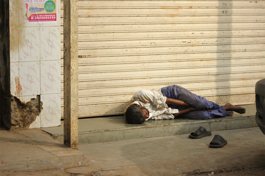 Photo of a man laying down in Mumbai, India.
