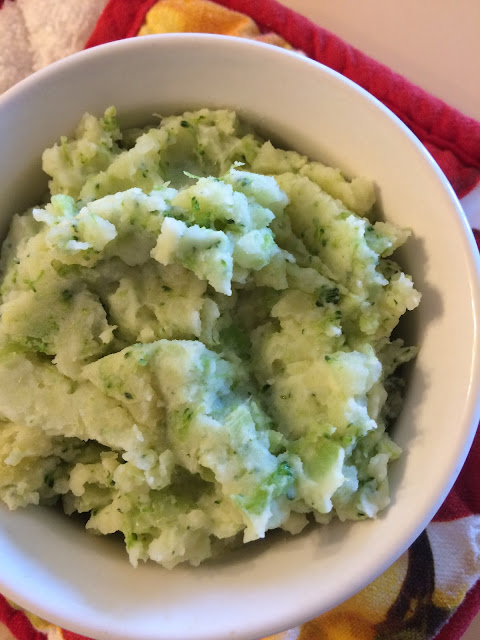 Potato, broccoli, and cheddar mash in a bowl.