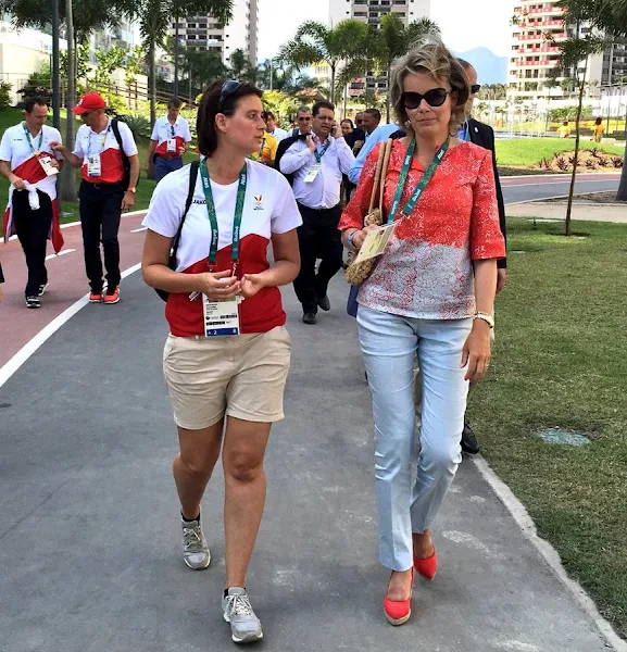 Queen Mathilde visited the Olympic Village, Queen wore Jeans trousers, printed blouse, wore Natan flat shoes, wore Cartier sungless Sunglasses, gold diamond earrings