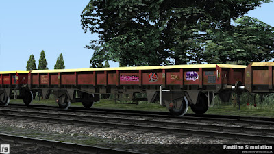 Fastline Simulation - ZCA Sea Urchin ex VDA [EWS]: A ZCA Sea Urchin converted from a lot 3908 VDA van is seen in a rake of similar wagons. The wagon appears to have been 'tagged' at some point and fiffering levels of weathering are evident when comparing the three wagons that can be seen.