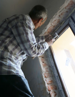 Removing the old damaged plaster Removing the old damaged plaster