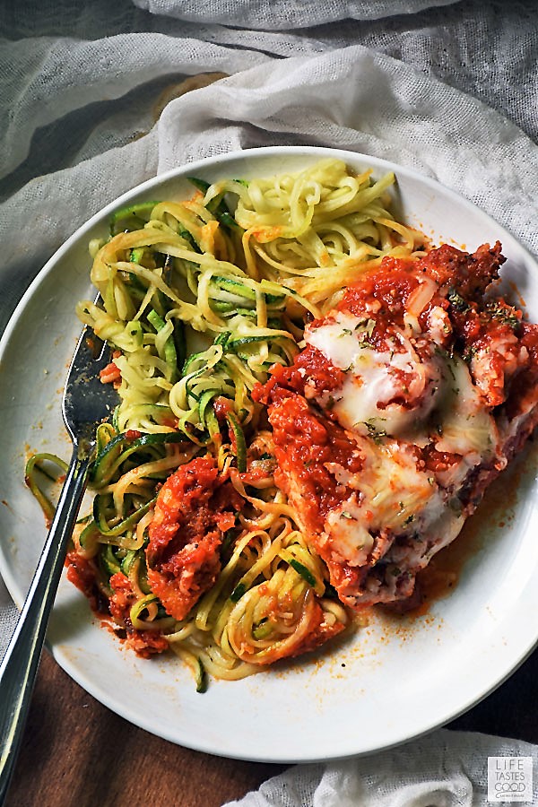 Keto Chicken Parm with a side of zoodles being eaten off a white plate