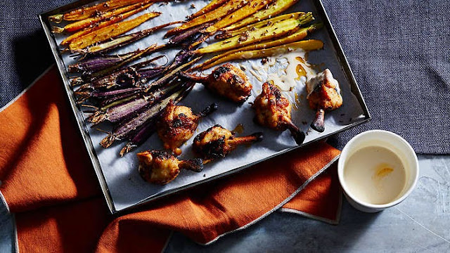 Spiced chicken wings with carrots and tahini in a tray