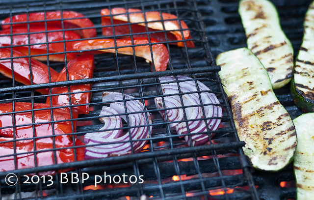 Grilling peppers, onions and zucchini to get a nice char on them.
