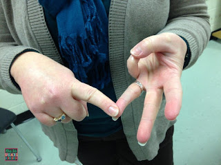 photo of teacher touching 3 fingers