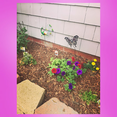 peacock and butterfly garden stakes and petunias