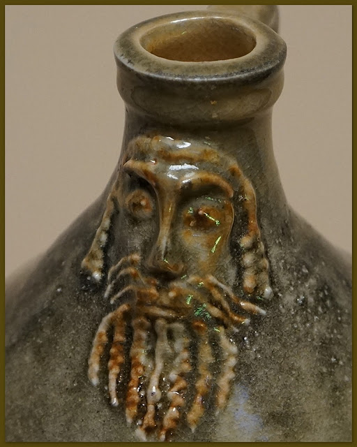 Closeup of pottery Bartmann or Bellarmine jug (replica) by Lily L.