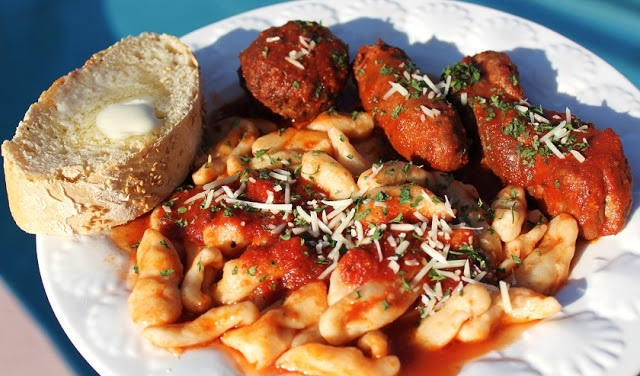 homemade pasta called cavatelli which is made from flour and ricotta with sauce and meatballs