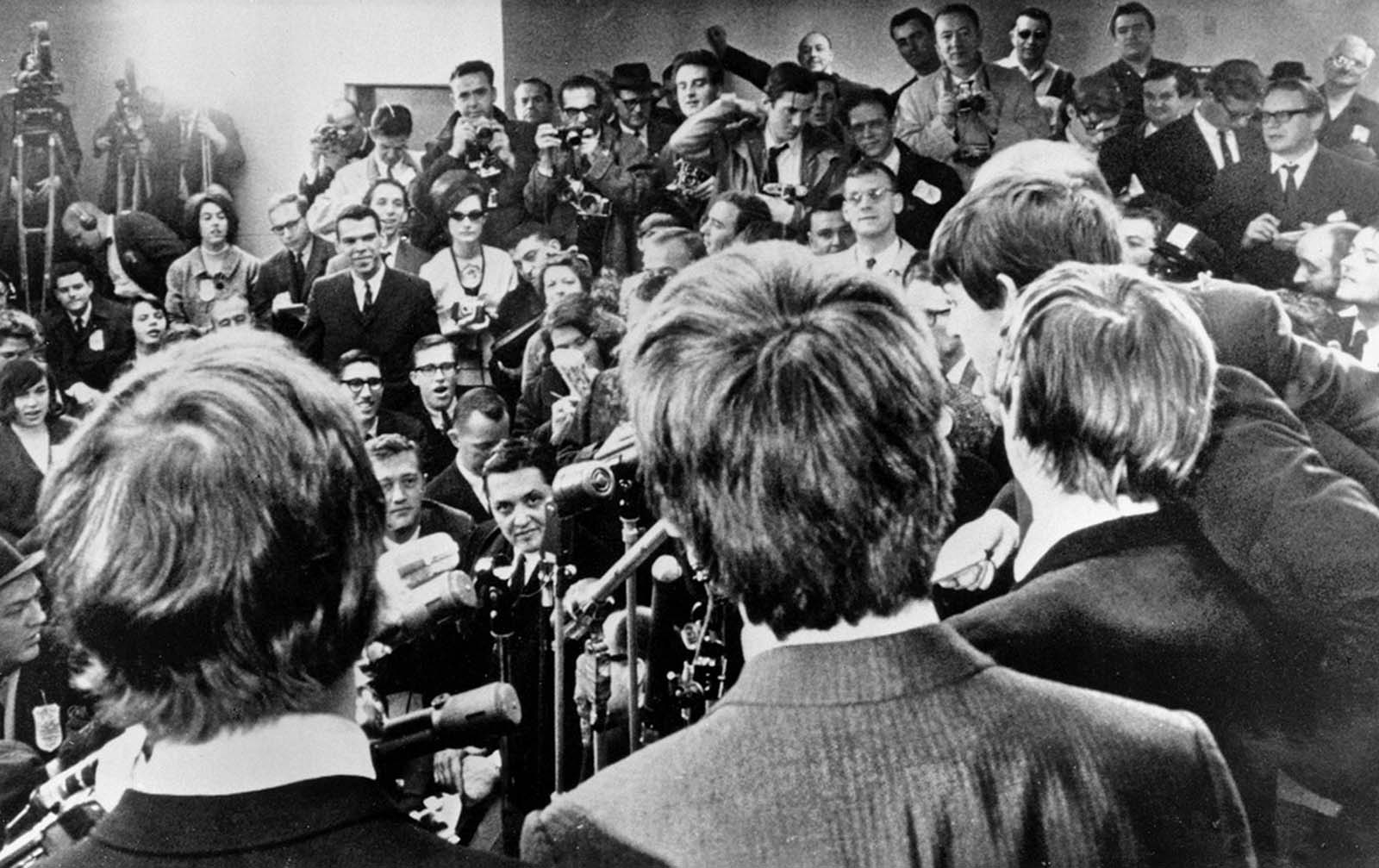 The Beatles face the media on their arrival in New York on February 7, 1964.