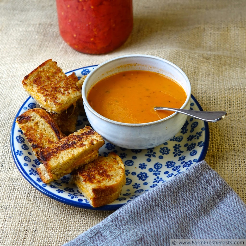 A creamy tomato soup made with home-canned tomatoes, pesto, and roasted garlic.