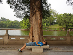 man sleeping on a stone bench at Zhongshan Park in Foshan