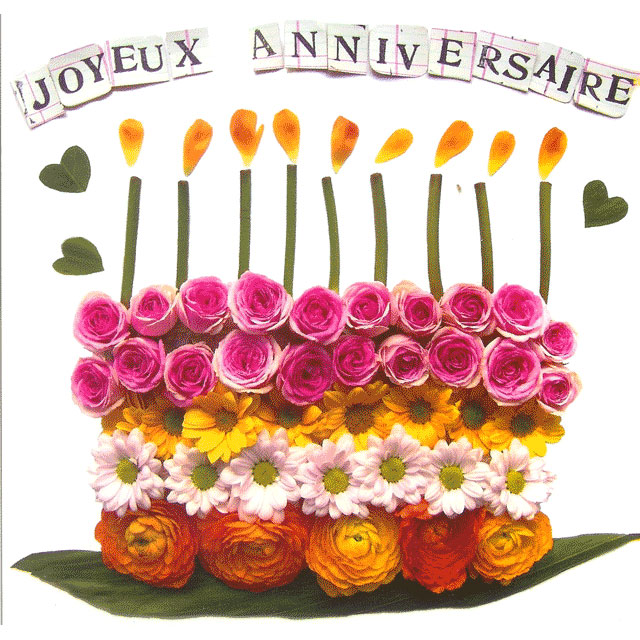 Gâteau formé avec des fleurs colorées Joyeux Anniversaire