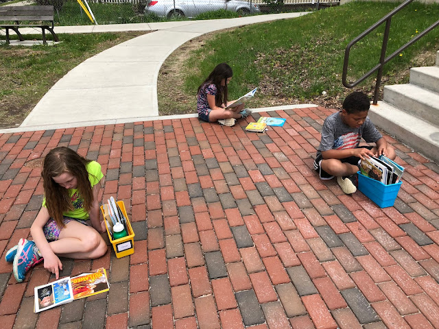 kids reading on bricks