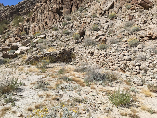 Staging area on the old road to the Betty Lee Mine Flat area created with rock walls against the steep canyon